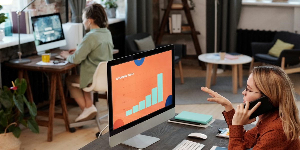 woman in MICE business discussing presentation on computer screen