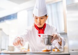 pastry chef adding final touches to dish